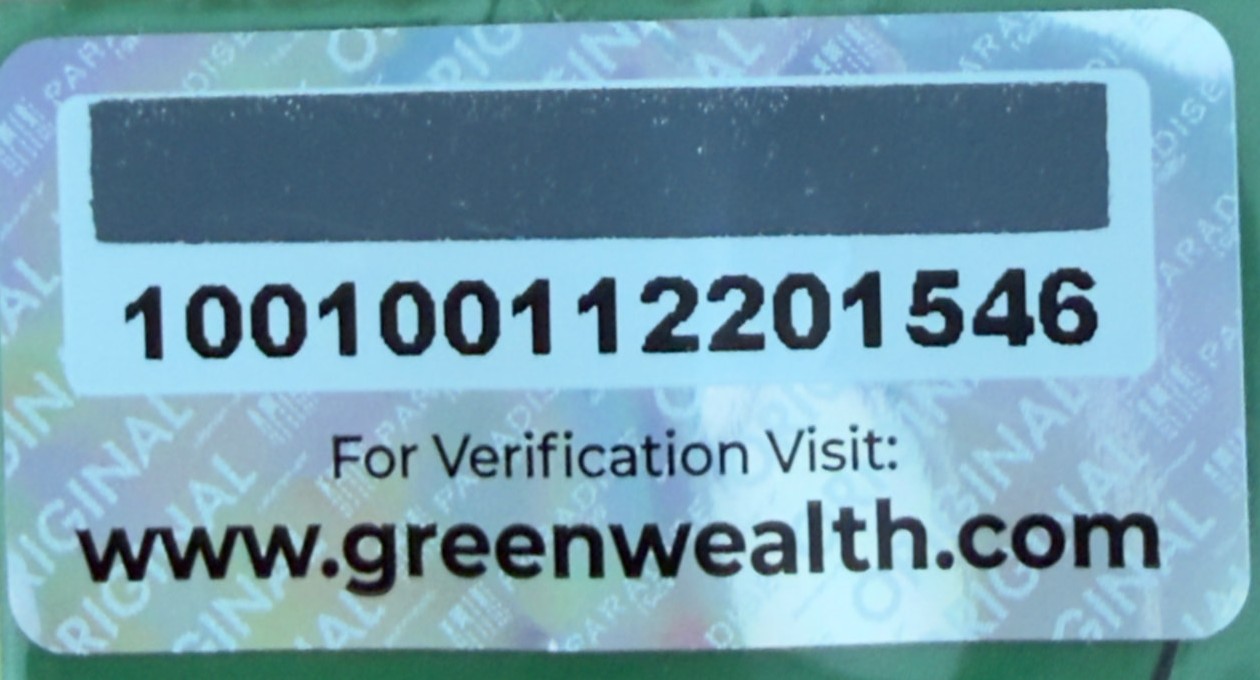 Genuine Green Wealth Neo Hair Lotion holographic authenticity sticker: black scratch-off panel hiding the 12 digit verification code, with the printed public serial number below